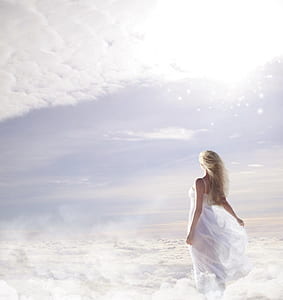 photo of woman in white spaghetti strap dress on clouds thumbnail