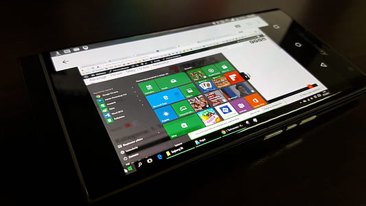 black smartphone on brown wooden surface thumbnail