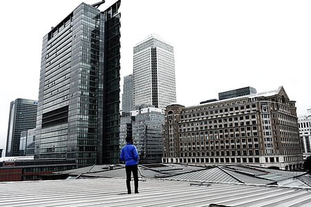 man standing on building rooftop thumbnail