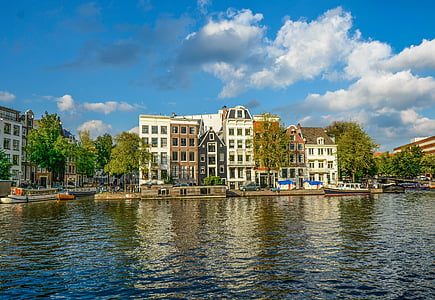 white concrete building near body of water during daytime thumbnail