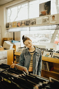 selective focus photography of woman in vinyl record store thumbnail