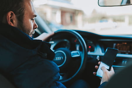 person using smartphone inside the car during daytime thumbnail