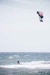 Surfboarding with surfing kite in the ocean thumbnail