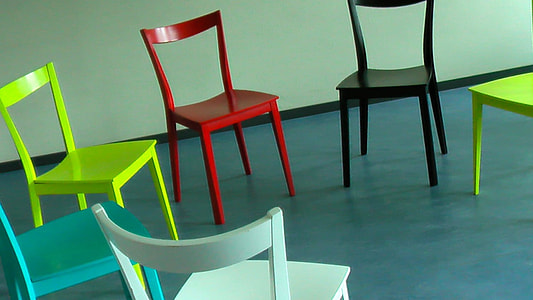 six assorted-color chairs on blue floor thumbnail