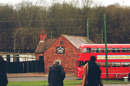 man and woman standing near brick house thumbnail
