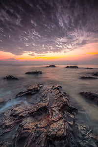 rock formation on body of water thumbnail
