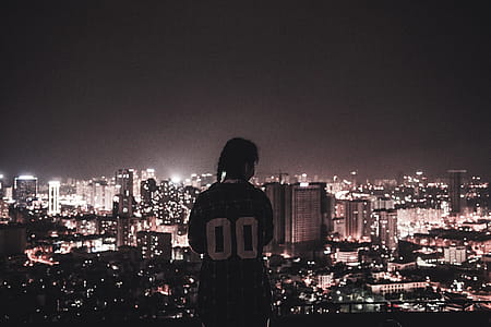 Photo of a Person Watching over City Lights during Night Time thumbnail