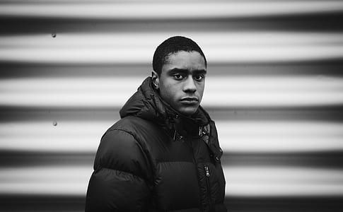 man wearing bubble hoodie beside white wall thumbnail