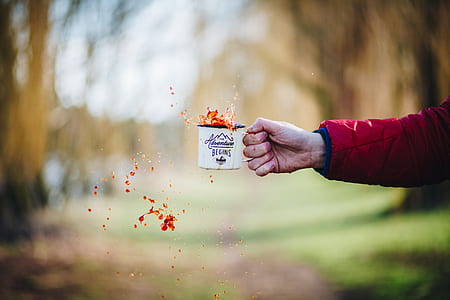 person holding white mug thumbnail