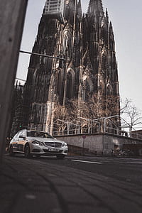 white vehicle near gray concrete wall thumbnail