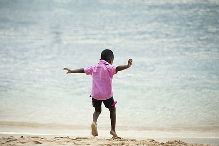 boy running alone going on seashore thumbnail