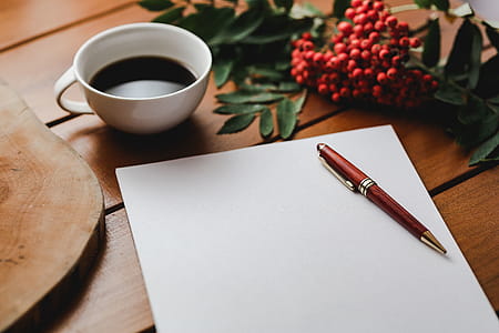 Red rowan fruit with a coffee and a white sheet of paper thumbnail