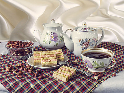 two white-and-purple ceramic teapots on top of red mat thumbnail