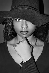 grayscale photography of woman with her left hand on her chin thumbnail