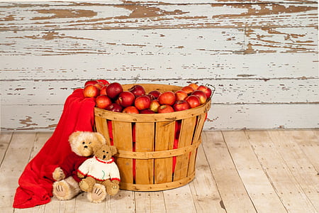two brown bear plush toys leaning on brown wooden basket with red apple fruit lot thumbnail