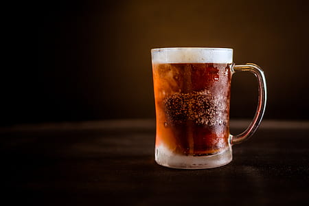 clear glass mug filled with brown cold fluid thumbnail