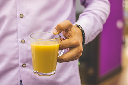Person Holding Mug Filled With Juice thumbnail