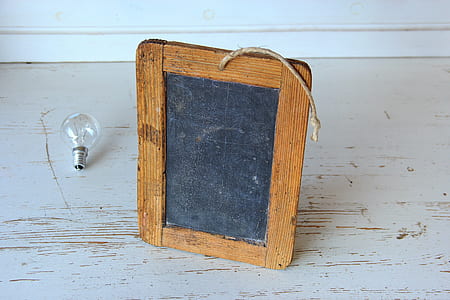 Brown Wooden Rectangular Photo Frame on White Wooden Table thumbnail
