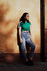 woman leaning on brown wall thumbnail