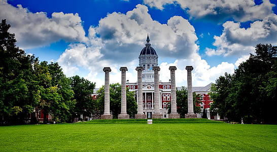 white and maroon building with dome under blue sky thumbnail