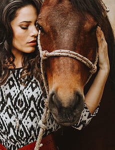 woman holding brown horse thumbnail