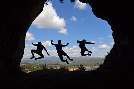 silhouette photo of three person hopping thumbnail