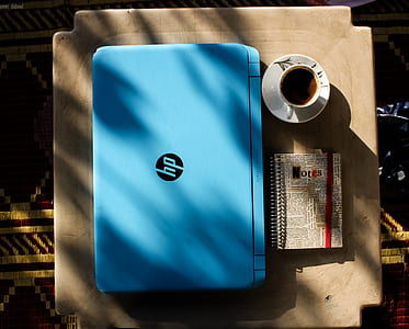 Blue Hp Laptop Near Notebook thumbnail
