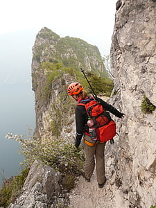 woman standing on mountain wearing red backpack thumbnail