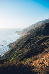 aerial photography of mountain near body of water thumbnail