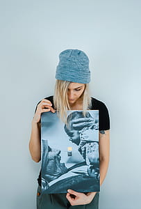 woman in black top holding photo of mother and daughter thumbnail