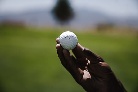 Selective Focus Photography of Person Holding Golf Ball thumbnail