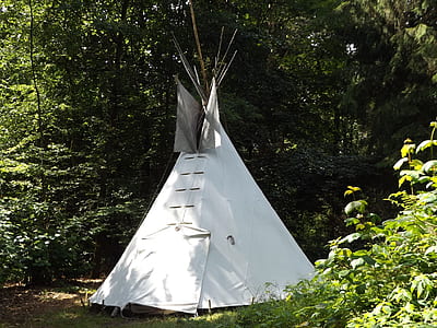 white tent in forest thumbnail