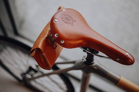 Brown leather saddle of bicycle thumbnail