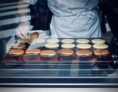 person wearing white suit baking pancakes thumbnail