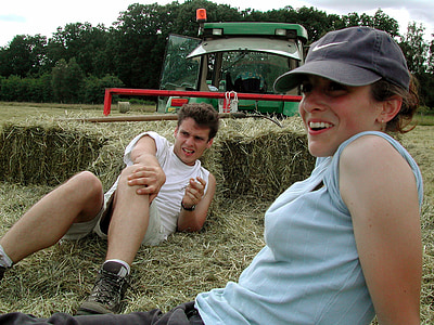 man and woman lying on ground of hay thumbnail