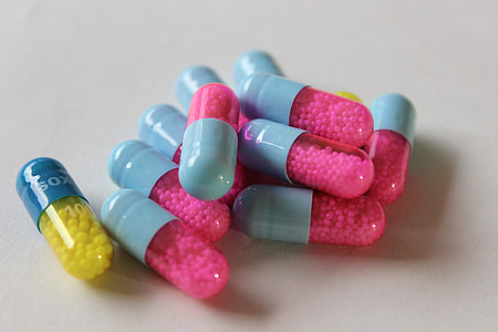 close-up photo of blue-and-pink capsules thumbnail