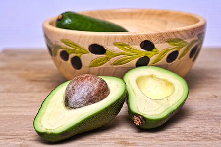 green sliced avocado on brown wooden table top thumbnail