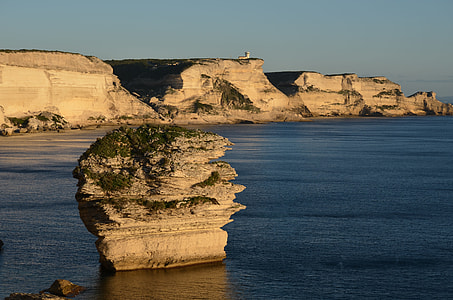 brown sea cliff on body of water thumbnail