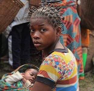 shallow focus photography of woman carrying a child thumbnail