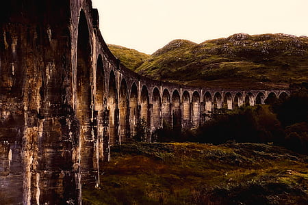 gray bridge beside mountain thumbnail
