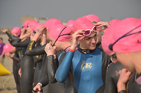 group of women wearing goggle standing on sand field at daytime thumbnail