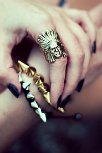 person holding gold-colored bracelets thumbnail