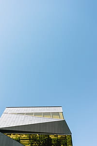 gray concrete building under blue sky thumbnail