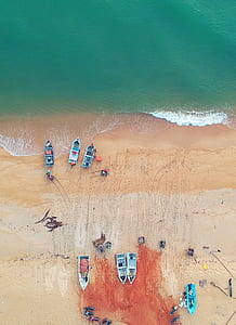 aerial photo of boats and people on seashore thumbnail