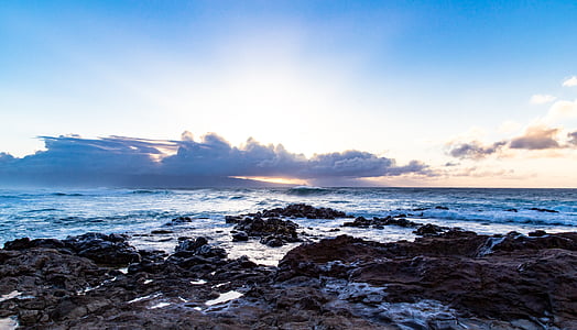 ocean with stones during sunset thumbnail