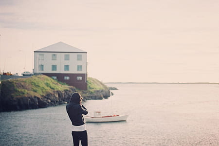 person standing near body of water thumbnail