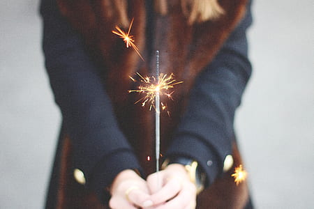 person's hand holding firecracke thumbnail