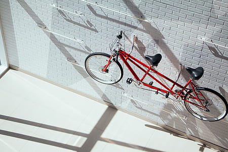 red tandem bike hanged on wall thumbnail
