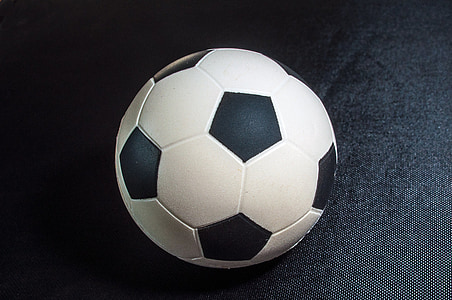 white and black soccer ball on black cloth thumbnail