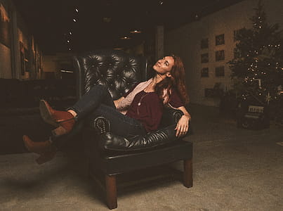 Woman Sitting on Black Leather Armchair thumbnail